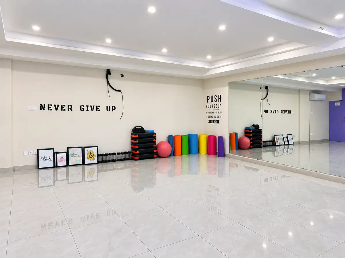 Bright mirrored fitness studio and exercise equipment at Alpha